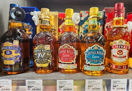 Photo for LATVIA, RIGA, 10, AUGUST, 2023: Chivas Regal 13 years old scottish whisky with special offers on a promotional trading stand in supermarket in Riga, Latvia. Chivas Regal is a brand of Scottish Whiskey - Royalty Free Image