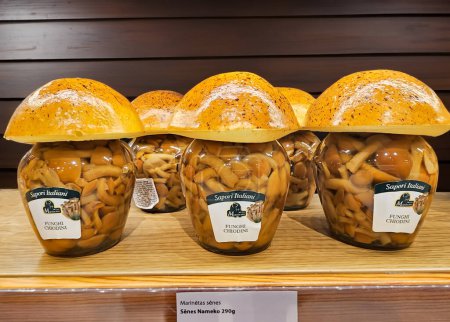 Photo for LATVIA, RIGA, 29, AUGUST, 2023: Glass jars in the shape of mushrooms with pickled funghi funghi pioppini in supermarker shelves, Riga. Latvia - Royalty Free Image