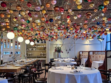 Photo for RUSSIA, MOSCOW, 05, JANUARY, 2024: Modern white interior with bright details and New Year decorations on the ceiling in a BURO TSUM restaurant, Moscow. Russia. - Royalty Free Image