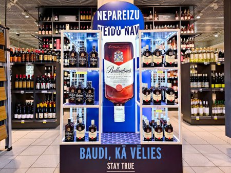 Photo for LATVIA, RIGA, 20, FEBRUARY, 2024: Promotional stand with Ballantine's blended Scotch whisky produced by the Chivas Brothers in Stockmann shopping mall, Riga. Latvia. - Royalty Free Image