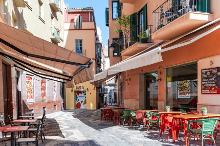 Photo for SPAIN, MALAGA, MAY, 29, 2023: Narrow streets of Malaga Old Town with tables on open air street cafe in Andalusia, Costa del Sol, Spain - Royalty Free Image