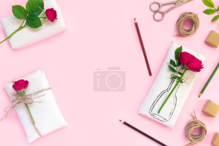 Photo for Set of wrapping paper and flowers for handmade on pink background. Homemade craft box gifts with painted vase, bouquet of red roses - Royalty Free Image