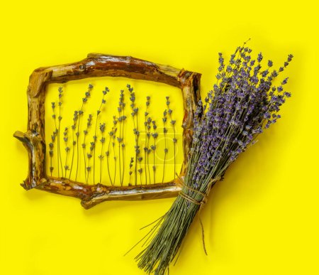 Photo for Wooden frames with  bouquet of fragrant lavender in  rustic style on yellow wall. Holiday party decoration. Vintage floral card. Interior concept. - Royalty Free Image
