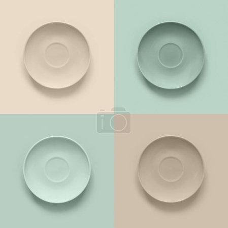 Photo for Beige  plates on turquoise table. Monochrome minimalistic image in hipster style - Royalty Free Image