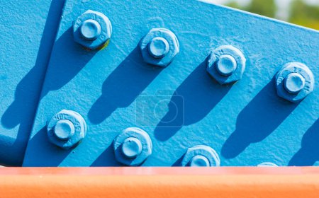 Photo for Metal plate painted blue and fixed with large steel bolt screws - Royalty Free Image