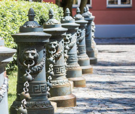 Photo for Decorative columns with lions and chains in the old town street. - Royalty Free Image