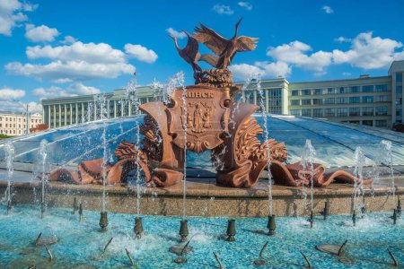 Photo for Sculpture of cranes fountain in Independence Square against the background of a blue sky with clouds Minsk , Belarus. - Royalty Free Image