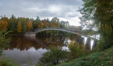 Photo for Arched bridge over Ogre river in autumn day Ogre, Latvia . - Royalty Free Image