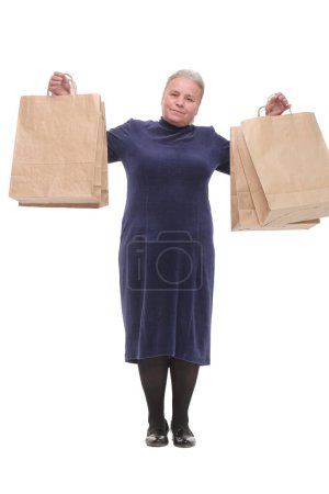Photo for Portrait of happy senior woman posing with her shopping bag looking at camera and smiling - Royalty Free Image