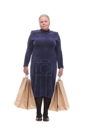 Photo for Mature woman holding bags smiling and looking at camera isolated over white background - Royalty Free Image