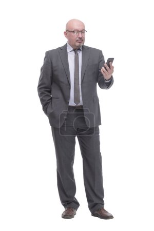 Téléchargez les photos : In full growth. business man with a smartphone.isolated on a white background. - en image libre de droit