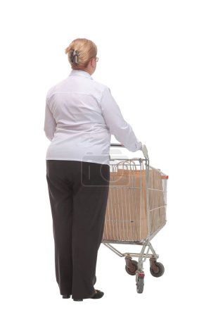 Rückansicht einer lässigen Frau mit leerem Einkaufswagen auf weißem Hintergrund. Einkaufskonzept