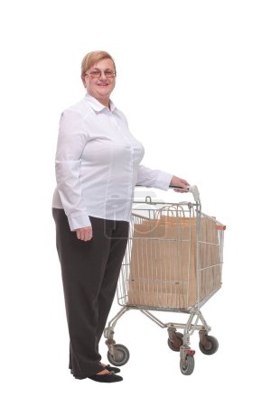 Full length shot of a mature woman pushing a shopping cart with shopping bags and looking at camera