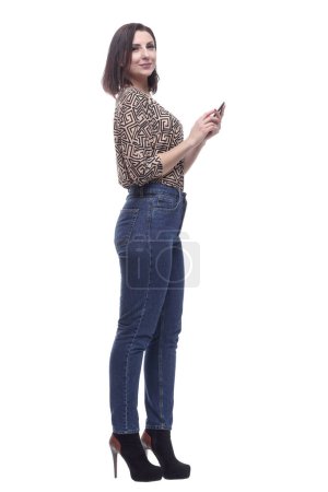 Photo for In full growth. attractive young woman with a smartphone. isolated on a white background. - Royalty Free Image