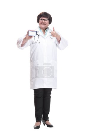 Photo for In full growth. senior female doctor showing her visiting card . isolated on a white background. - Royalty Free Image