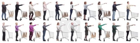 Photo for A group of people with a shopping cart point their fingers in front of them on a white background - Royalty Free Image