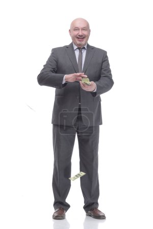 Foto de In full growth. smiling business man with dollar bills.isolated on a white background. - Imagen libre de derechos