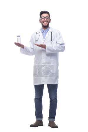 Photo for In full growth. smiling doctor pointing at hand sanitizer . isolated on a white background. - Royalty Free Image