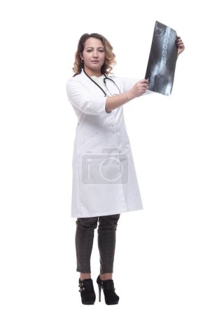 Photo for Young female doctor looking at an x-ray. isolated on a white background. - Royalty Free Image