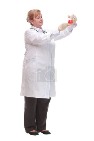 Photo for Smiling scientist or doctor holding a flask gives the thumbs up. Isolated on white. - Royalty Free Image