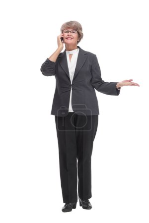 Photo for Senior businesswoman in black outfit and wearing glasses talking on smartphone - Royalty Free Image