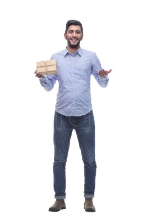 Photo for In full growth. happy young man with a gift in craft-paper. isolated on a white background. - Royalty Free Image