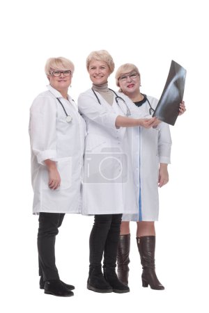 Photo for In full growth. group of qualified doctors discussing an x-ray. isolated on a white background. - Royalty Free Image