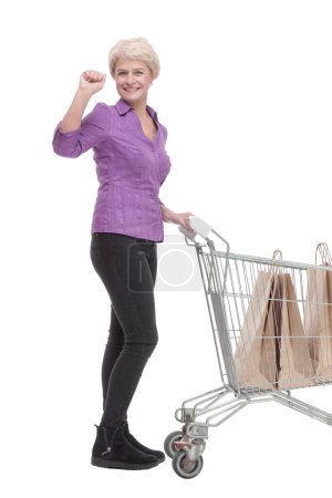 Photo for In full growth. casual mature woman with shopping cart. isolated on a white background. - Royalty Free Image