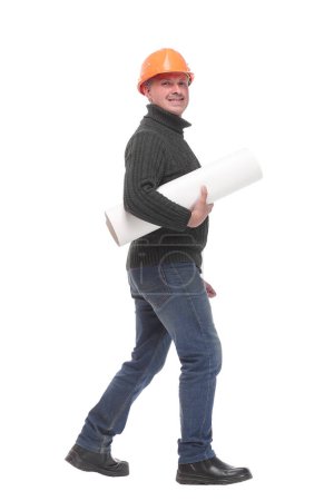 Photo for Side view of architect man in orange color hardhat holding blueprints walking and looking away - Royalty Free Image