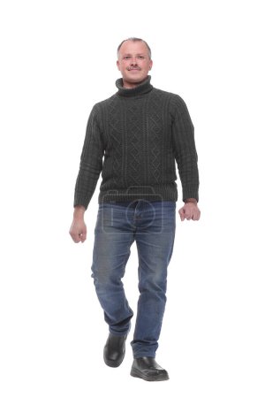 Photo for Full length picture of a casual senior man walking towards the camera with a smile on his face. isolated on white background - Royalty Free Image