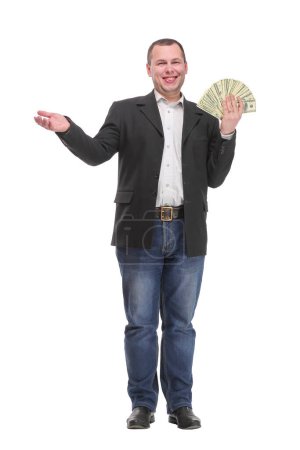 Foto de Retrato de un joven sonriente sosteniendo una moneda de papel estadounidense ventilada aislada sobre fondo blanco - Imagen libre de derechos
