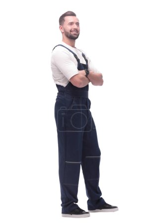 Photo for Side view. smiling man in overalls looking forward to copy space. isolated on white background - Royalty Free Image