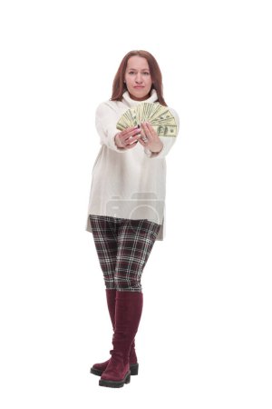 in full growth. casual happy woman with banknotes .isolated on a white background.