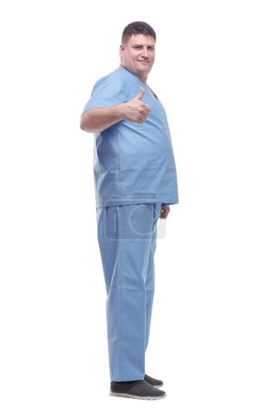Foto de Vista lateral. un médico masculino con uniforme azul. aislado sobre un fondo blanco. - Imagen libre de derechos