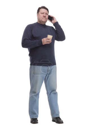 Foto de Hombre maduro casual con teléfono inteligente y café para llevar .isolated sobre un fondo blanco. - Imagen libre de derechos