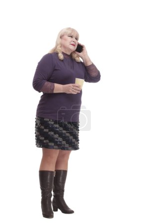 Photo for Casual mature woman with smartphone and coffee to takeaway . isolated on a white background. - Royalty Free Image