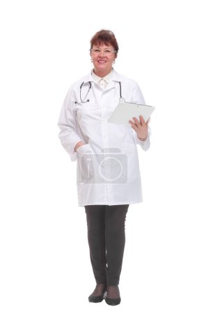 Female doctor wearing a white coat and using a digital tablet, looking at camera with serious expression