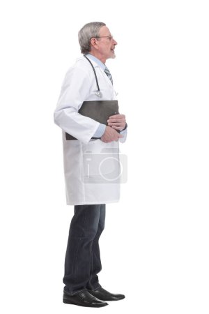 Photo for A mature doctor holding a clipboard and posing isolated against white background and looking at camera - Royalty Free Image
