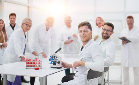 young scientist and his colleagues work in the laboratory. concept of health protection.