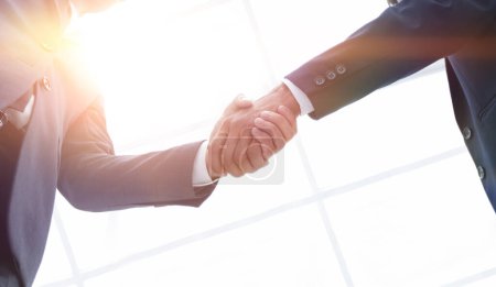 Photo for Two confident business man shaking hands during a meeting in the office, success, dealing, greeting and partner concept. - Royalty Free Image