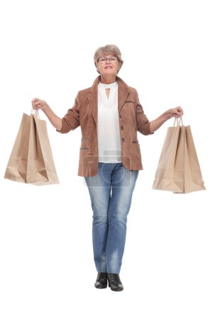 Foto de Happy senior woman with shopping bags on white background looking at camera - Imagen libre de derechos