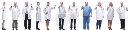 Photo for Full length group of doctors showing badge isolated on white background - Royalty Free Image