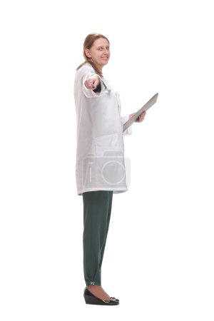 Téléchargez les photos : Vue latérale du médecin féminin remplissant le formulaire médical sur le presse-papiers. Concept de santé, d'assurance et de médecine - en image libre de droit