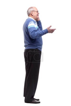 Photo for In full growth. the older man is choosing a contact in his smartphone. isolated on a white background - Royalty Free Image
