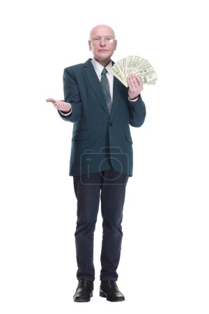Photo for Side view. personable business man with a wad of dollar bills. isolated on a white background. - Royalty Free Image