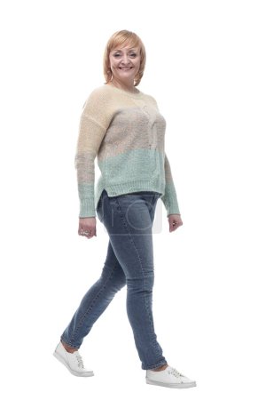 Téléchargez les photos : Sur toute la longueur. femme décontractée en jeans marchant vers l'avant. isolé sur un fond blanc. - en image libre de droit