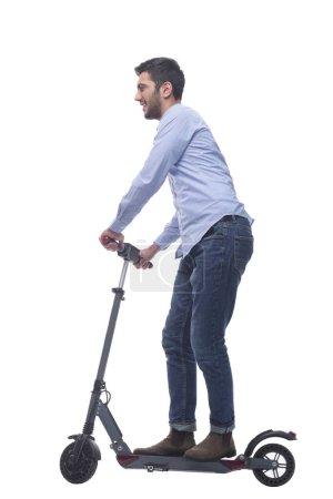 Foto de Vista lateral. joven atractivo con un scooter eléctrico. aislado sobre un fondo blanco. - Imagen libre de derechos