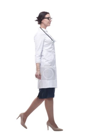 Photo for Confident female doctor with a stethoscope striding forward. isolated on a white background. - Royalty Free Image