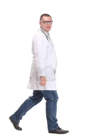 Full length studio shot of walking young male doctor with stethoscope, side view. isolated on white. puzzle 637855752