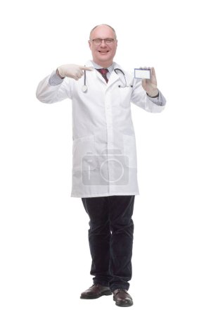 Photo for In full growth. smiling mature doctor showing his visiting card. - Royalty Free Image